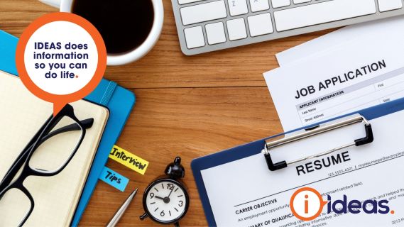 Job application and résumé froms on a desk with reading glasses, folder, keyboard and coffee