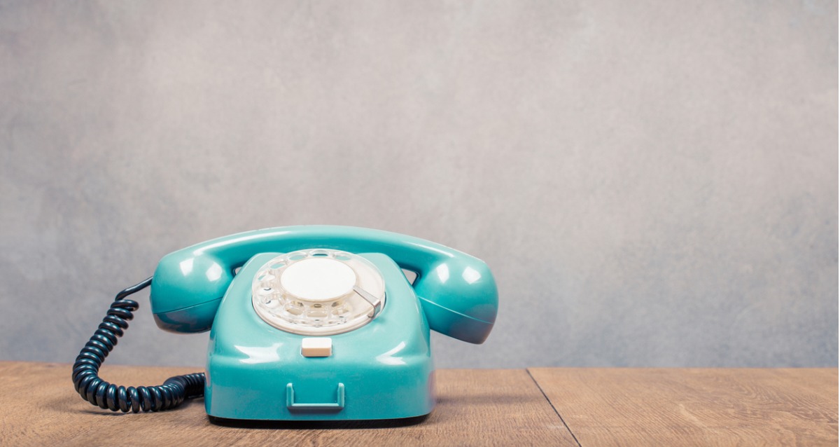 mint green rotary phone on a desk