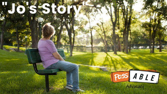 Woman sit on a park bench and looks away from the camera