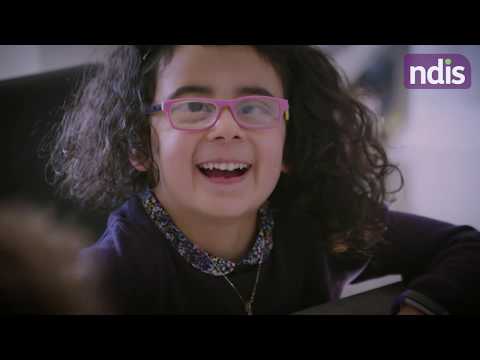 Young girl with pink glasses looking up and smiling